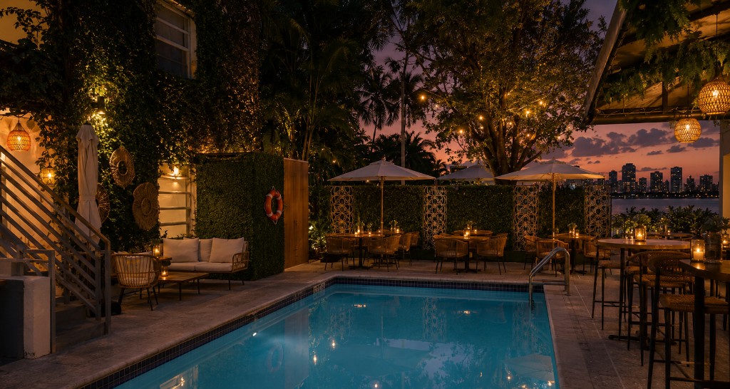 Evening pool ambiance with golden-hour lighting and Miami skyline views